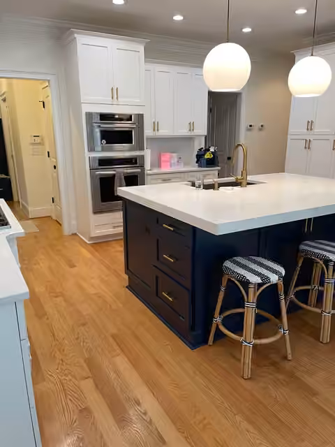 Clean white kitchen with navy island